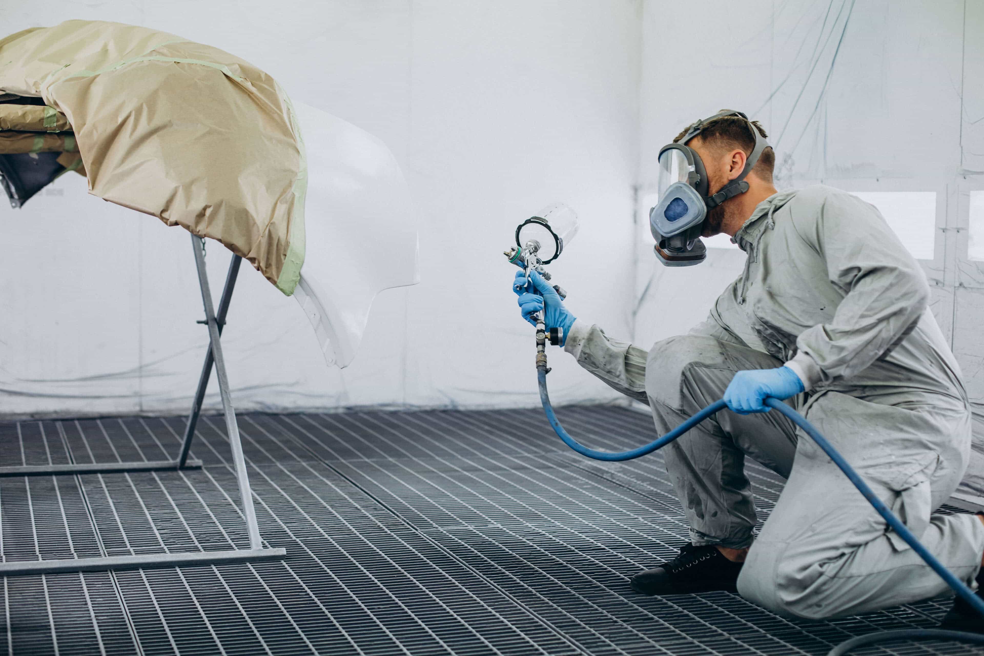 car-mechanic-painting-car-with-spray-gun